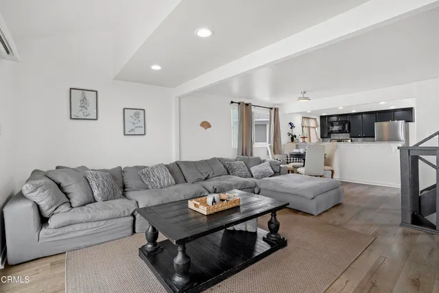 a living room with furniture and kitchen view