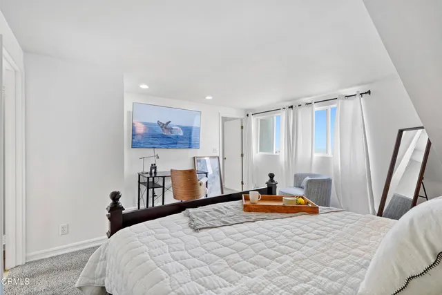 a bedroom with a bed and a large mirror