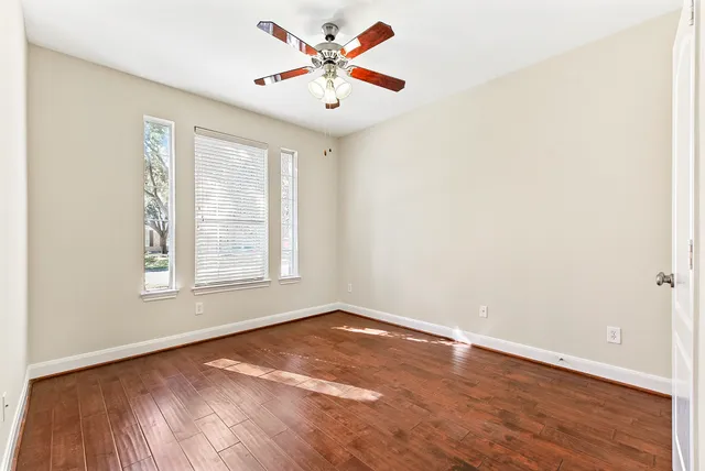 a view of a small space with wooden floor and a window