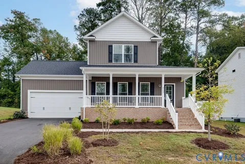 a front view of a house with a yard garage and outdoor seating