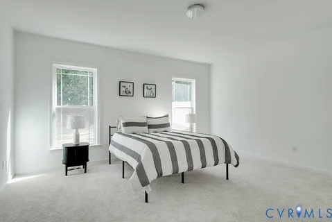 a bed room with a bed and a window