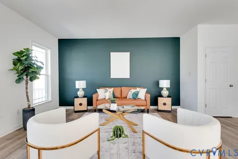 a living room with furniture and a potted plant
