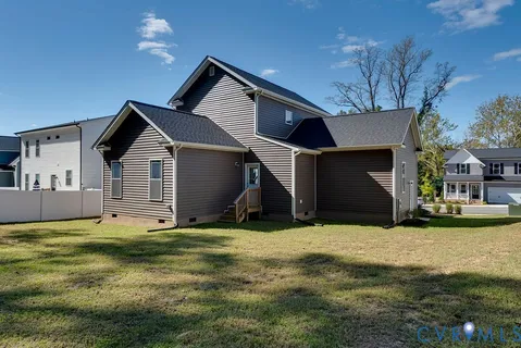 a front view of a house with a yard and fountain in middle