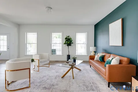 a living room with furniture a rug and a window