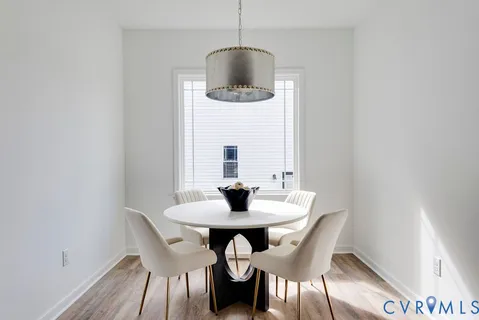 a dining room with furniture and wooden floor