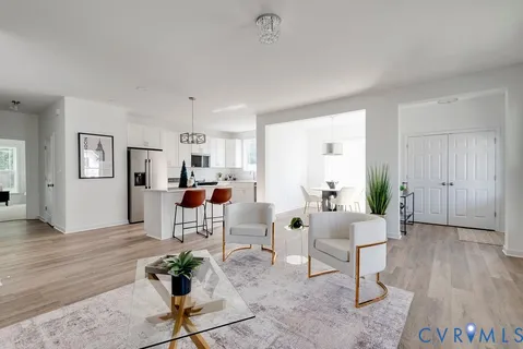 a living room with furniture and wooden floor