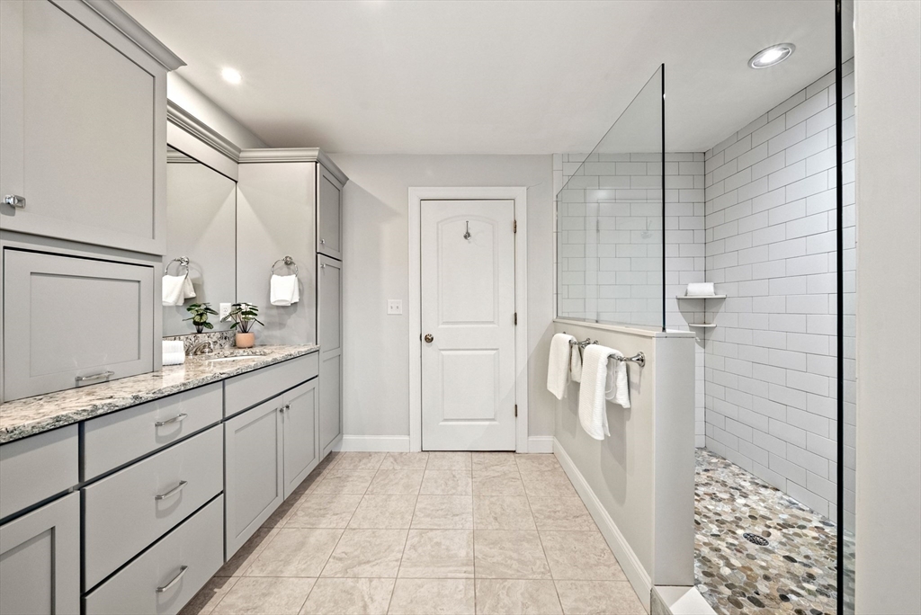 45 Saddleback Lane Canton, MA 02021 - Photo 20 of 42 a bathroom with a sink a mirror and a shower