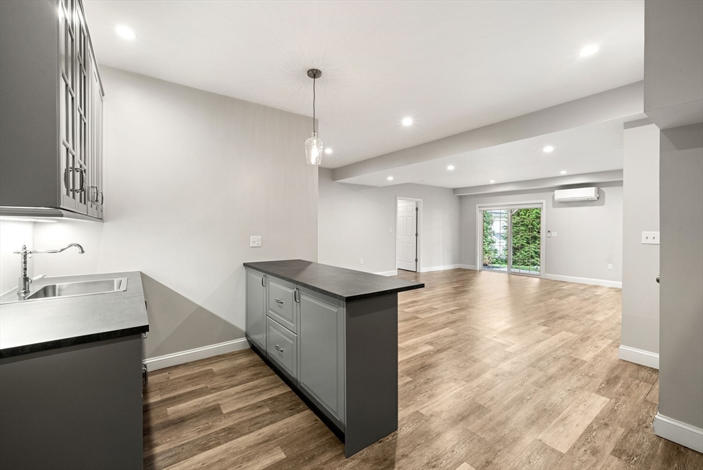 45 Saddleback Lane Canton, MA 02021 - Photo 28 of 42 a kitchen with stainless steel appliances granite countertop a sink a stove and a wooden floors