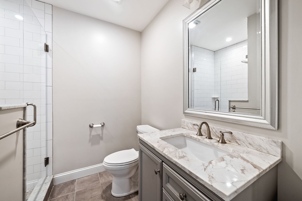 45 Saddleback Lane Canton, MA 02021 - Photo 33 of 42 a bathroom with a granite countertop sink toilet and a mirror
