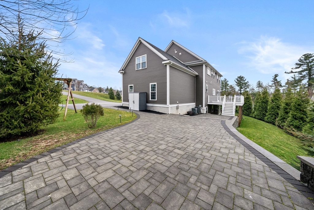 45 Saddleback Lane Canton, MA 02021 - Photo 35 of 42 a front view of a house with a yard and trees