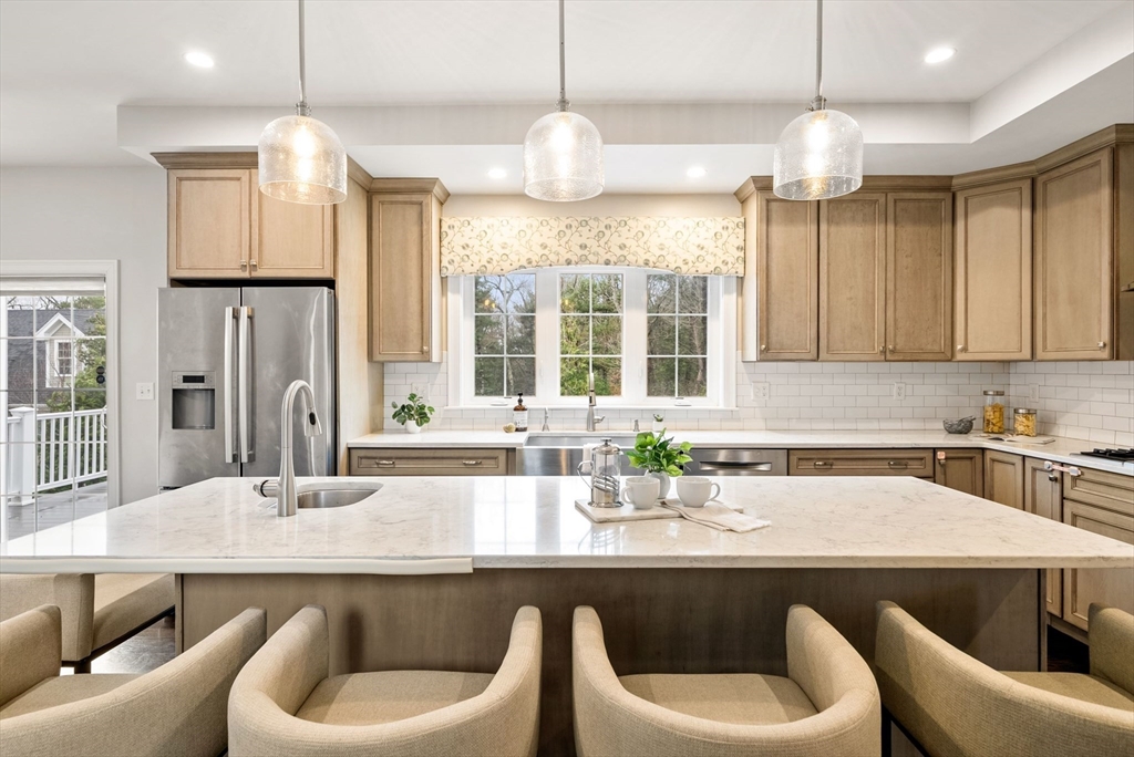 45 Saddleback Lane Canton, MA 02021 - Photo 4 of 42 a kitchen with a table chairs sink and cabinets