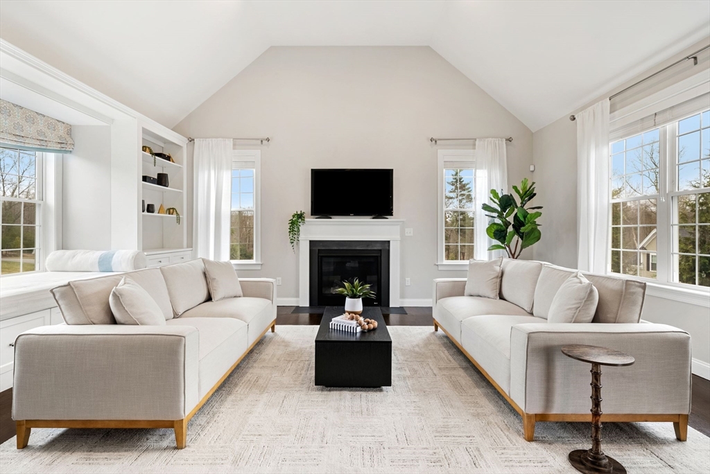 45 Saddleback Lane Canton, MA 02021 - Photo 8 of 42 a living room with furniture a flat screen tv and a fireplace