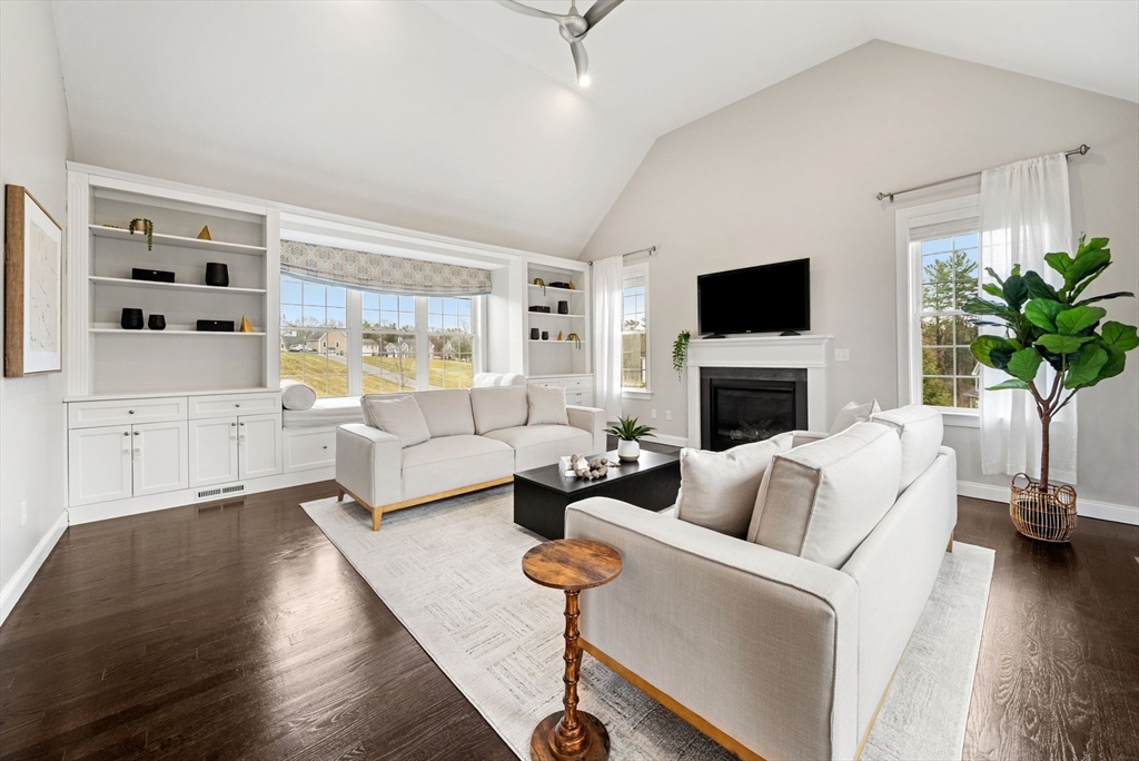 45 Saddleback Lane Canton, MA 02021 - Photo 9 of 42 a living room with furniture a fireplace and a flat screen tv