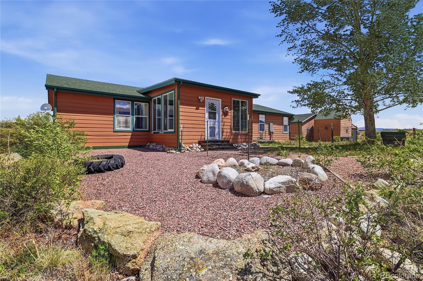 20300 Old Ranch Loop Nathrop, CO 81236 - Photo 22 of 35 a front view of a house with garden and plants
