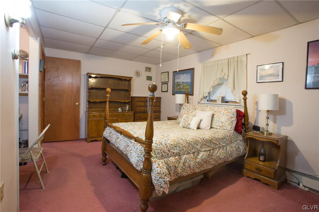 222 Cherry Hill Road Nazareth, PA 18064 - Photo 13 of 31 a bed room with a bed and a chandelier