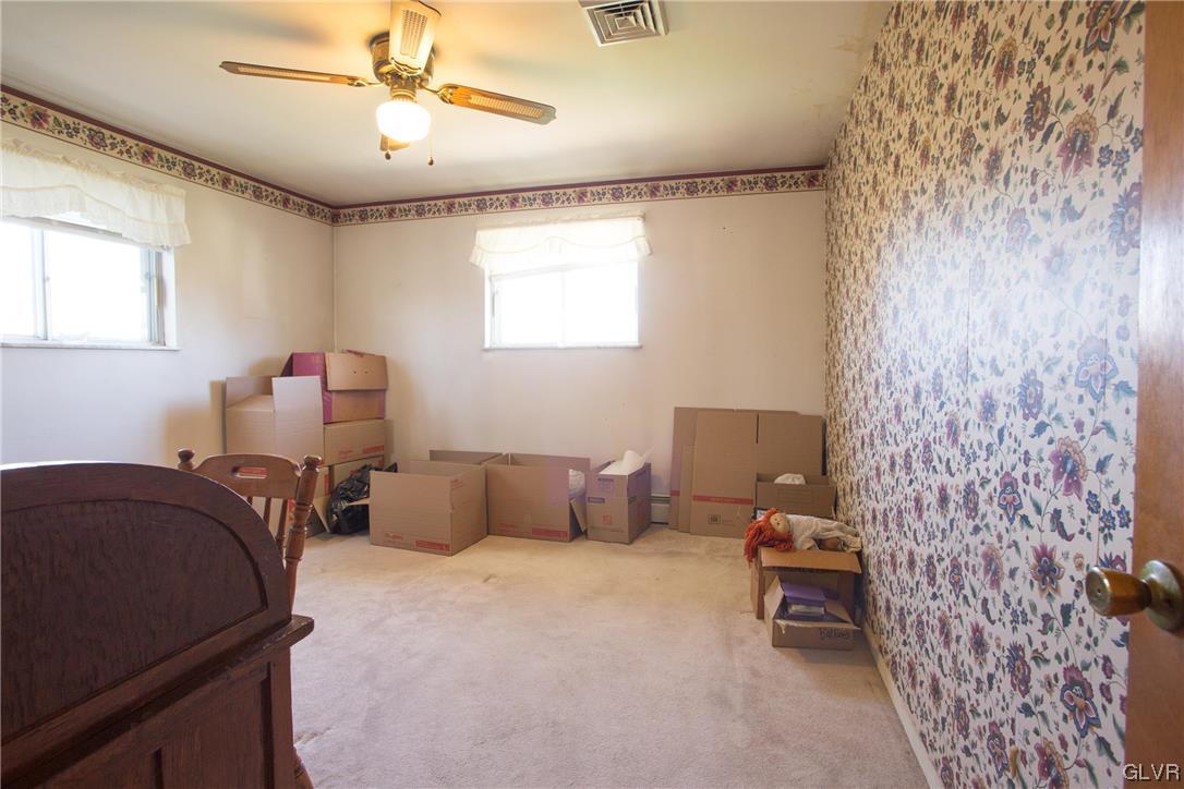 222 Cherry Hill Road Nazareth, PA 18064 - Photo 10 of 31 a bedroom with a bed and a chandelier