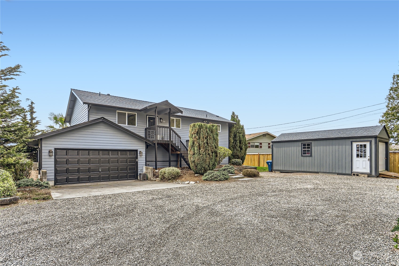 21712 Calhoun Road Monroe, WA 98272 - Photo 2 of 37 a front view of a house with a yard and garage