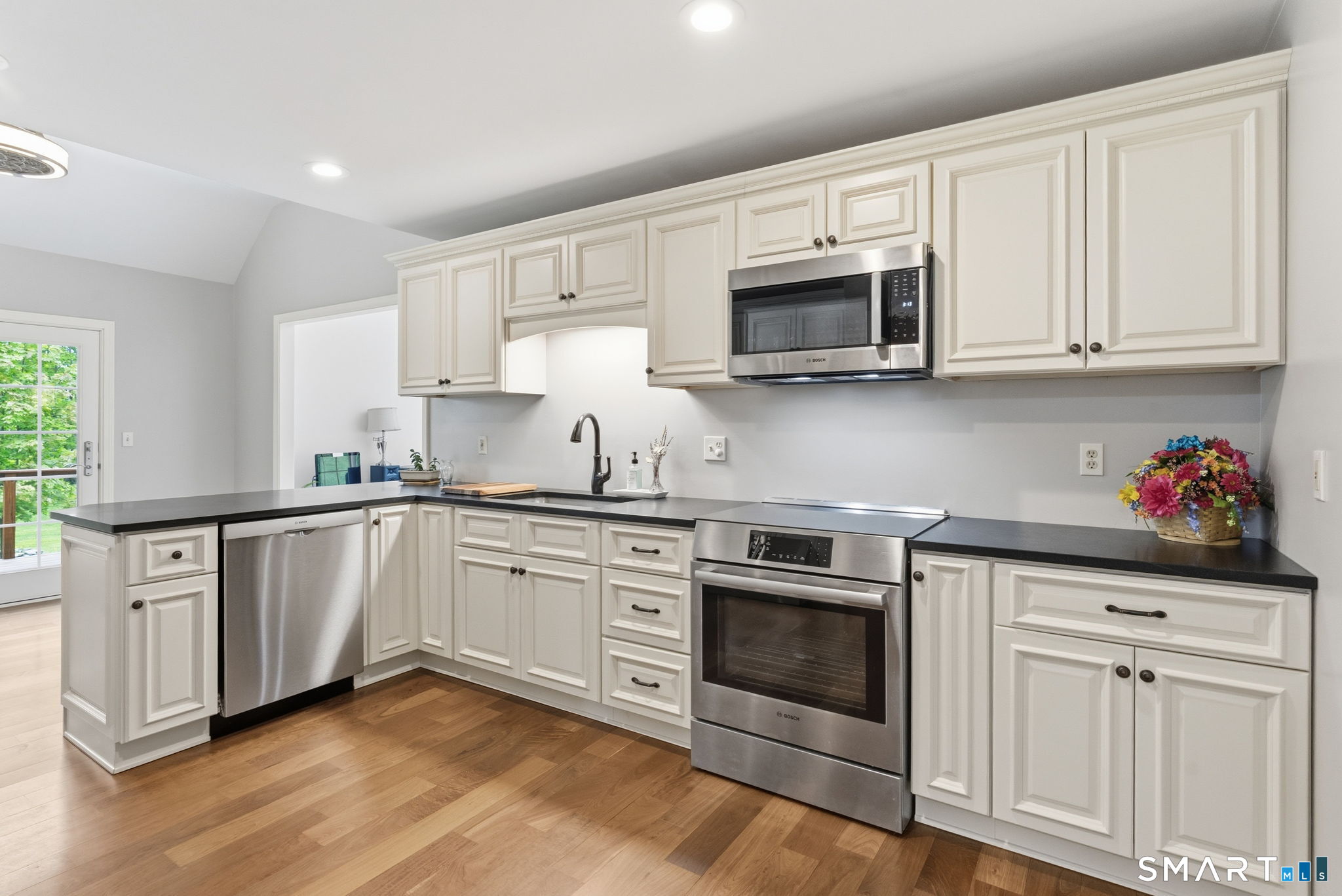 287 South Bear Hill Road Chaplin, CT 06235 - Photo 14 of 37 a kitchen with stainless steel appliances granite countertop a stove and white cabinets
