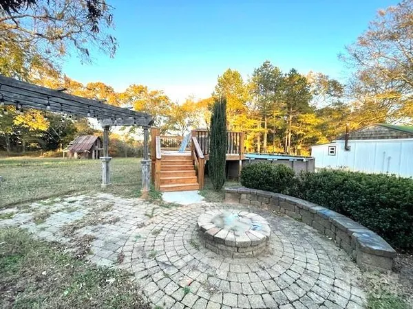 a view of a entrance gate of the house and trees