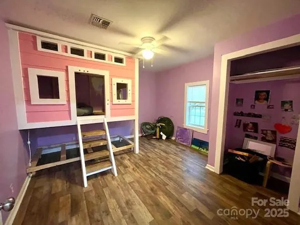 a view of a hallway view with wooden floor and closet