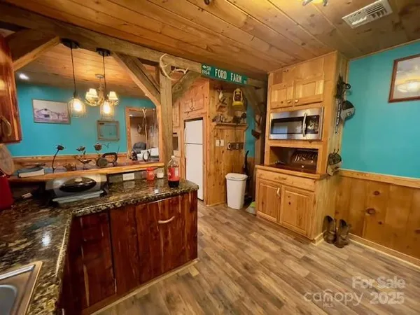 a view of kitchen with furniture and fireplace