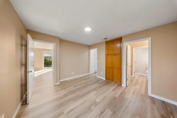 a view of a big room with wooden floor and natural light