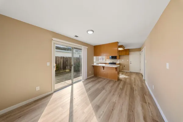 a view of a kitchen with wooden floor
