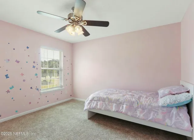 a view of a bedroom with a fan and a fan