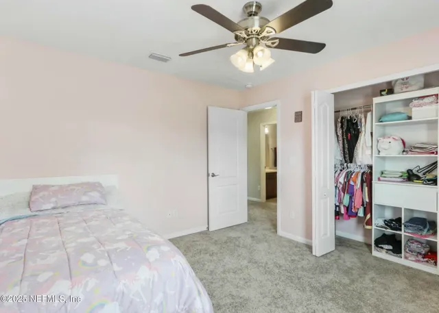 a spacious bedroom with a bed and window