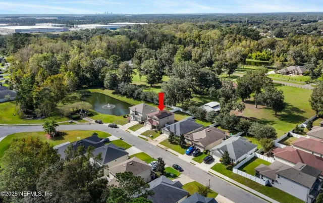 an aerial view of a house with a garden and swimming pool