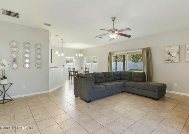 a dining room with furniture a chandelier and window