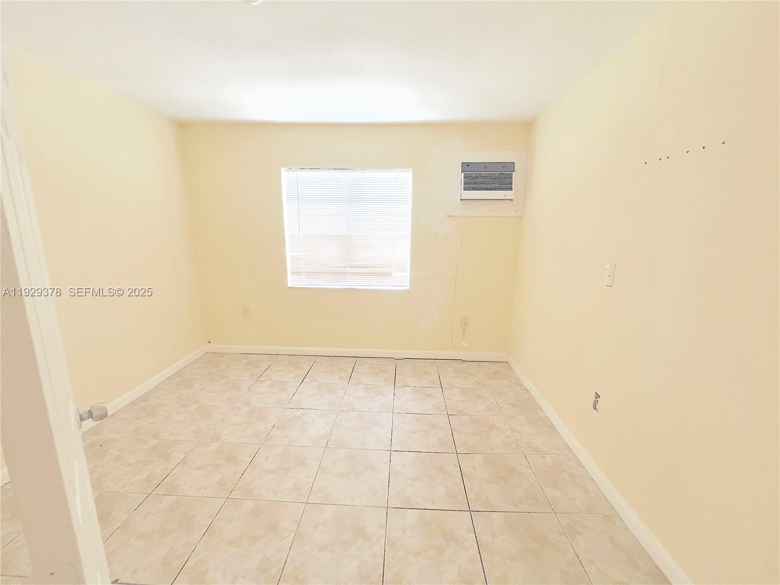 236 East 14th Street, Unit B Hialeah, FL 33010 - Photo 14 of 16 a view of an empty room with a window