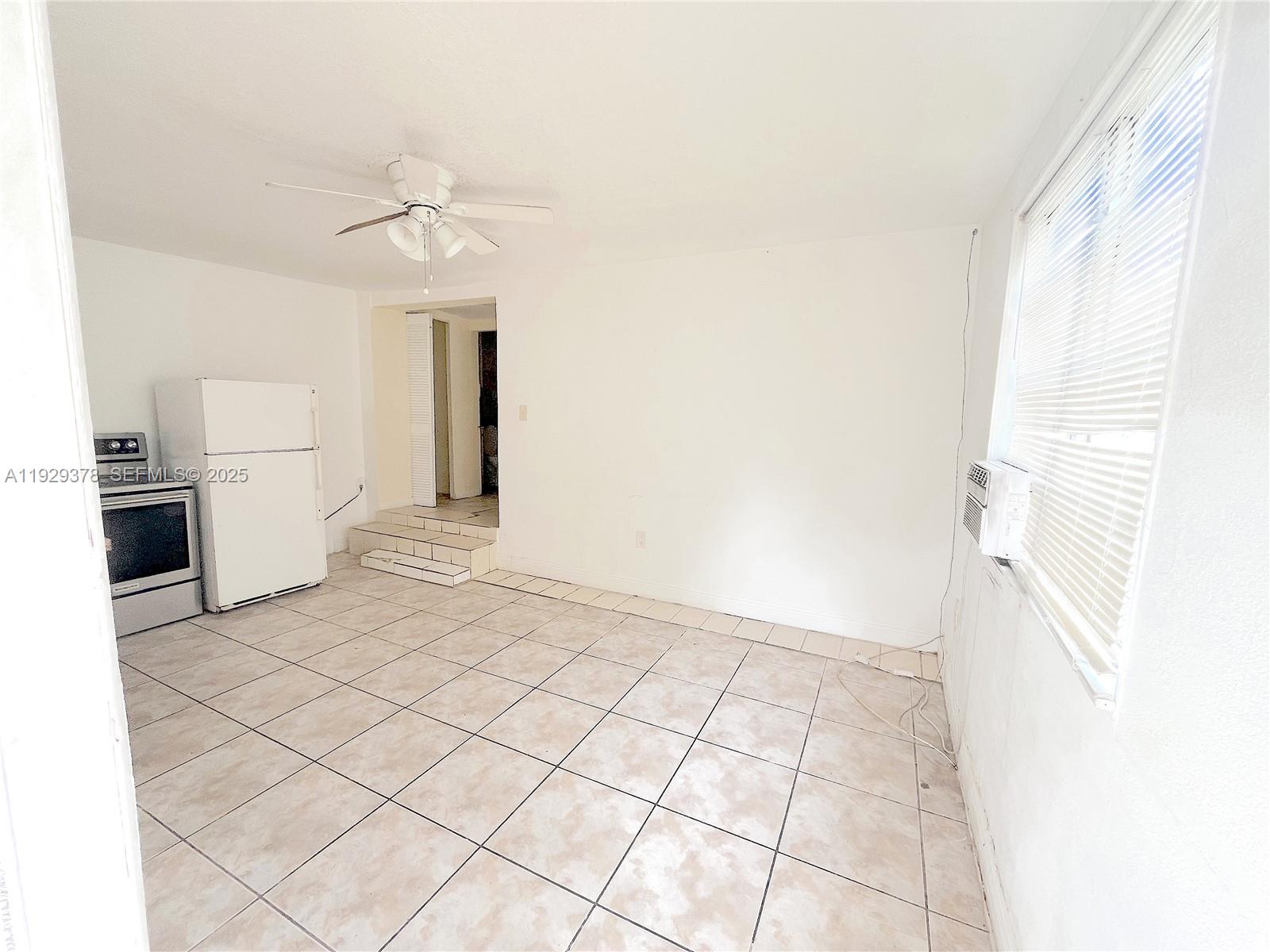236 East 14th Street, Unit B Hialeah, FL 33010 - Photo 7 of 16 a view of a kitchen with a sink and a microwave