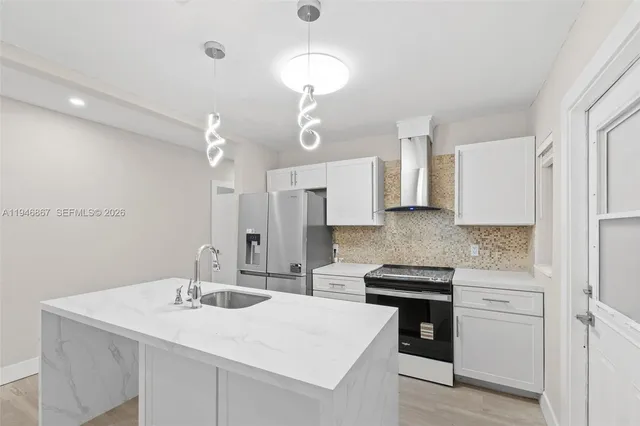 a kitchen with a sink stove and refrigerator
