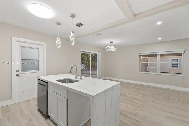 a kitchen with sink and microwave