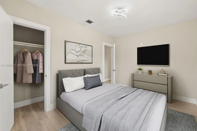 a bedroom with a bed and a flat screen tv