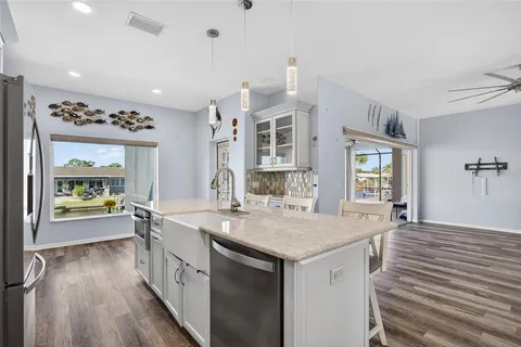 a kitchen with granite countertop a stove and cabinets