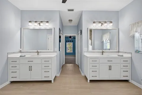 a bathroom with a tub a sink and a window