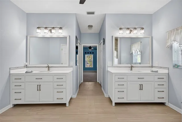 a bathroom with a tub a sink and a window