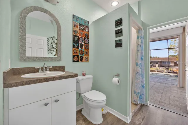 a bedroom with a bed flat screen tv and a window