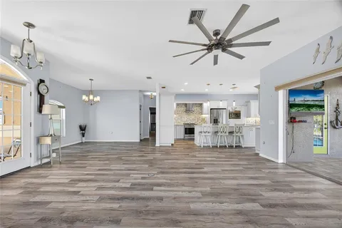 a view of empty room with wooden floor and window