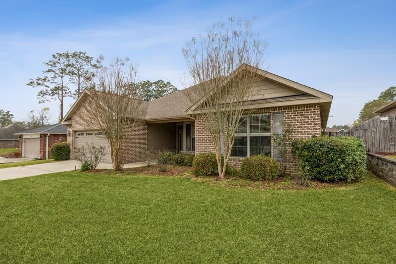 4609 Hermosa Road Crestview, FL 32539 - Photo 1 of 34 a front view of a house with a garden and yard