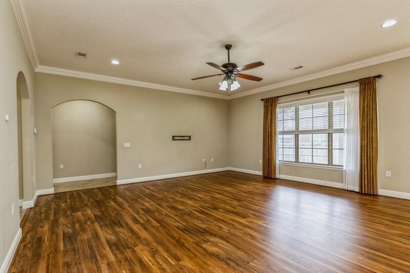 4609 Hermosa Road Crestview, FL 32539 - Photo 11 of 34 a view of an empty room with a window and wooden floor