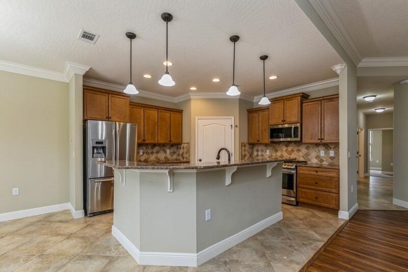 4609 Hermosa Road Crestview, FL 32539 - Photo 12 of 34 a kitchen with stainless steel appliances granite countertop a sink a stove and a refrigerator