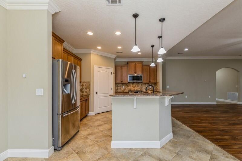 4609 Hermosa Road Crestview, FL 32539 - Photo 13 of 34 a kitchen with stainless steel appliances granite countertop a refrigerator a sink and a stove
