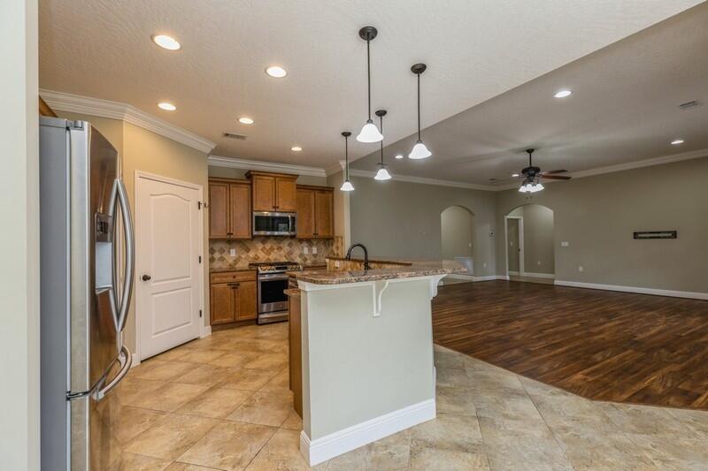 4609 Hermosa Road Crestview, FL 32539 - Photo 14 of 34 a kitchen with kitchen island a sink stainless steel appliances and cabinets