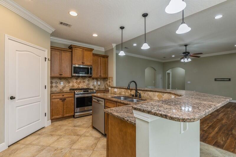 4609 Hermosa Road Crestview, FL 32539 - Photo 16 of 34 a kitchen with a sink a stove a refrigerator and a microwave