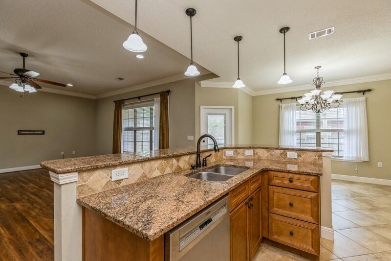 4609 Hermosa Road Crestview, FL 32539 - Photo 17 of 34 a kitchen with center island chandelier and living room view