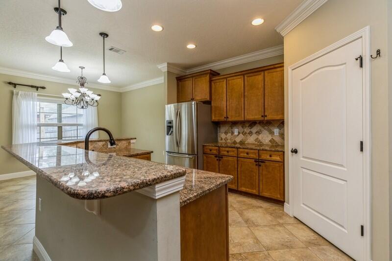 4609 Hermosa Road Crestview, FL 32539 - Photo 18 of 34 a kitchen with a refrigerator a sink and cabinets