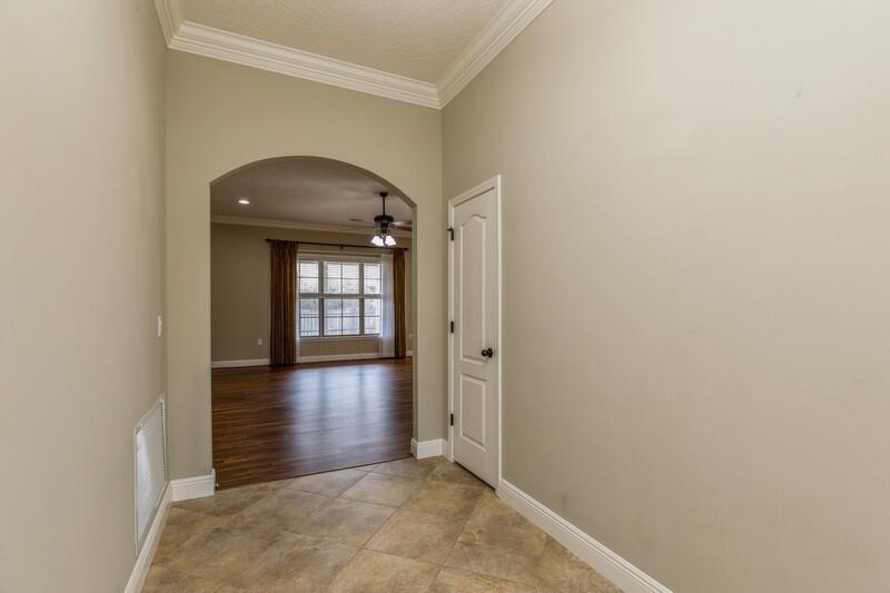 4609 Hermosa Road Crestview, FL 32539 - Photo 6 of 34 an empty room with wooden floor and windows